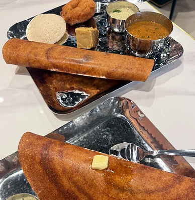 Rolled dosa with idli, vada and sambar