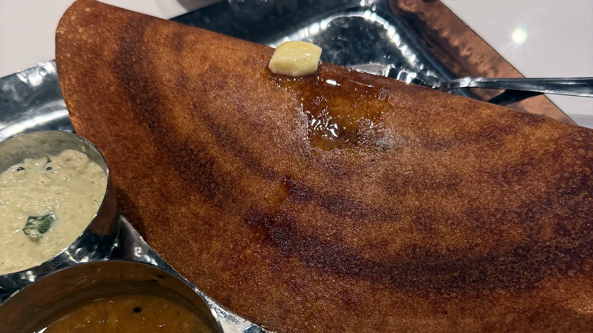 Bangalore-style dosa with butter, coconut chutney and sambar on a steel tray